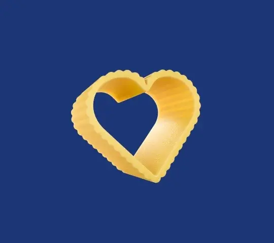 A single heart-shaped piece of pasta on a dark blue background
