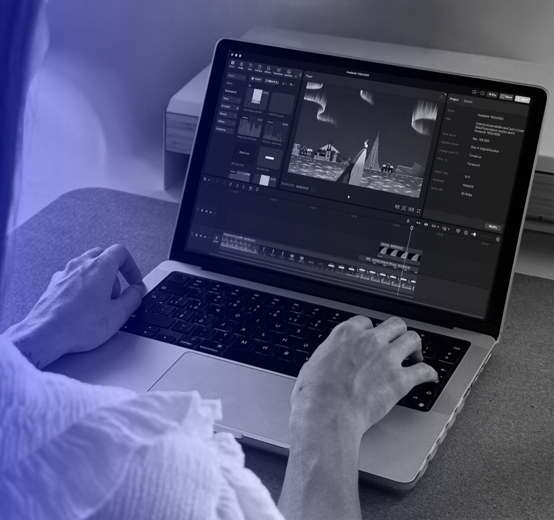 Working on a digital animation on a laptop: the Hvalavinir whale and Reykjavik scene in the video editor